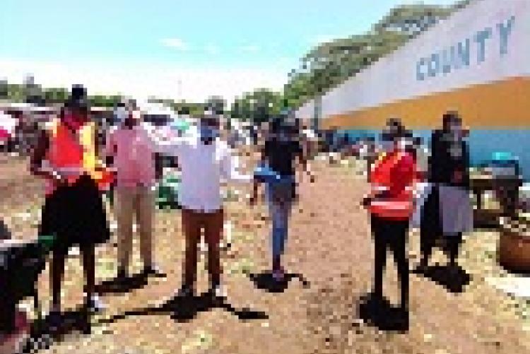 Students at the market place distributing masks