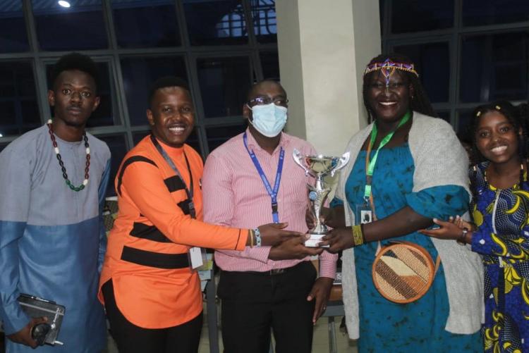 Receiving the trophy on behalf of the school during the Awarding Ceremony from the KMUN Secretary General and Zetech University's Administrative representative. 